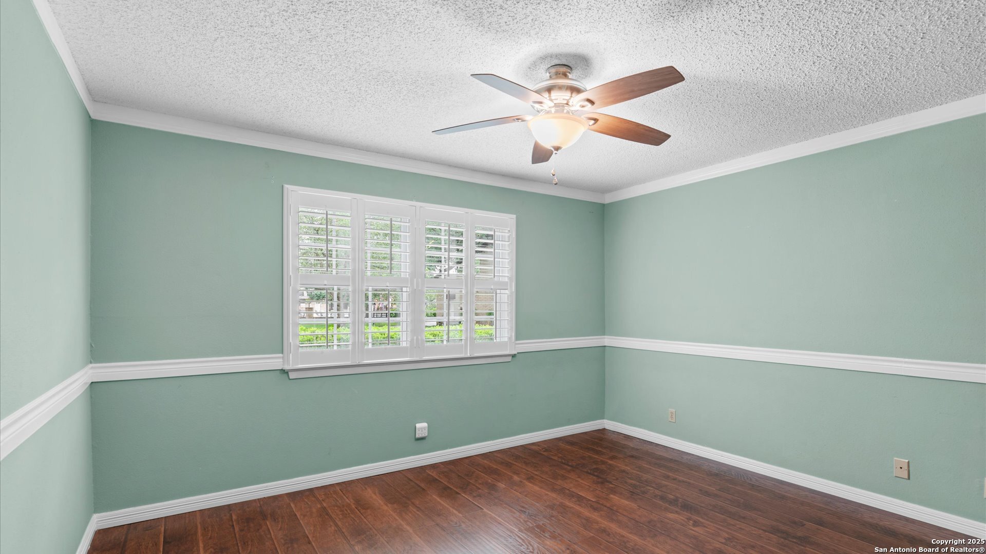 6750 Crown Ridge San Antonio, TX 78239 - Photo 17 of 31 a view of an empty room with wooden floor and a window