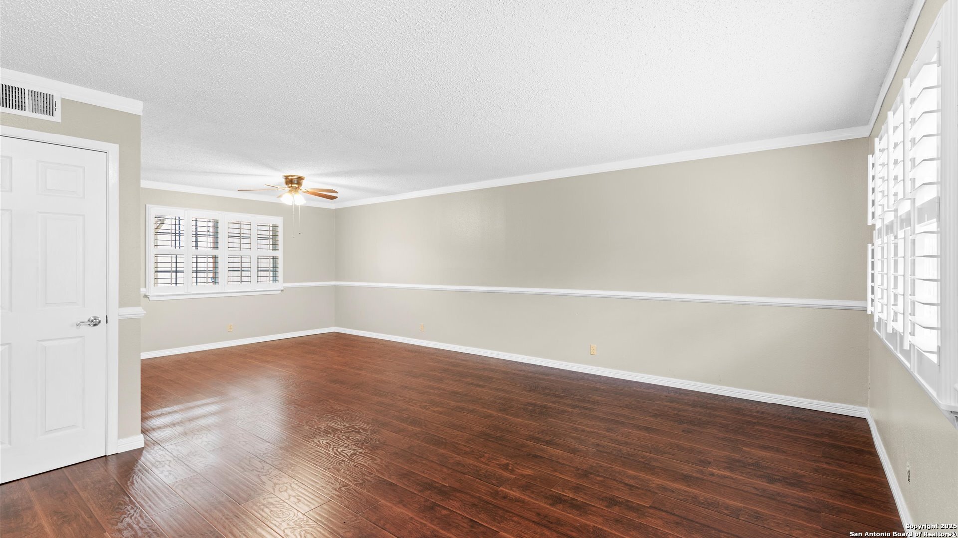 6750 Crown Ridge San Antonio, TX 78239 - Photo 4 of 31 an empty room with wooden floor and windows