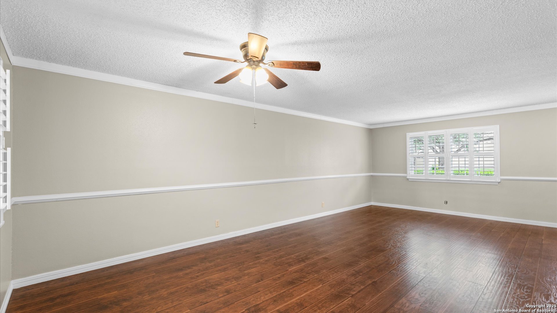 6750 Crown Ridge San Antonio, TX 78239 - Photo 7 of 31 an empty room with wooden floor fan and windows