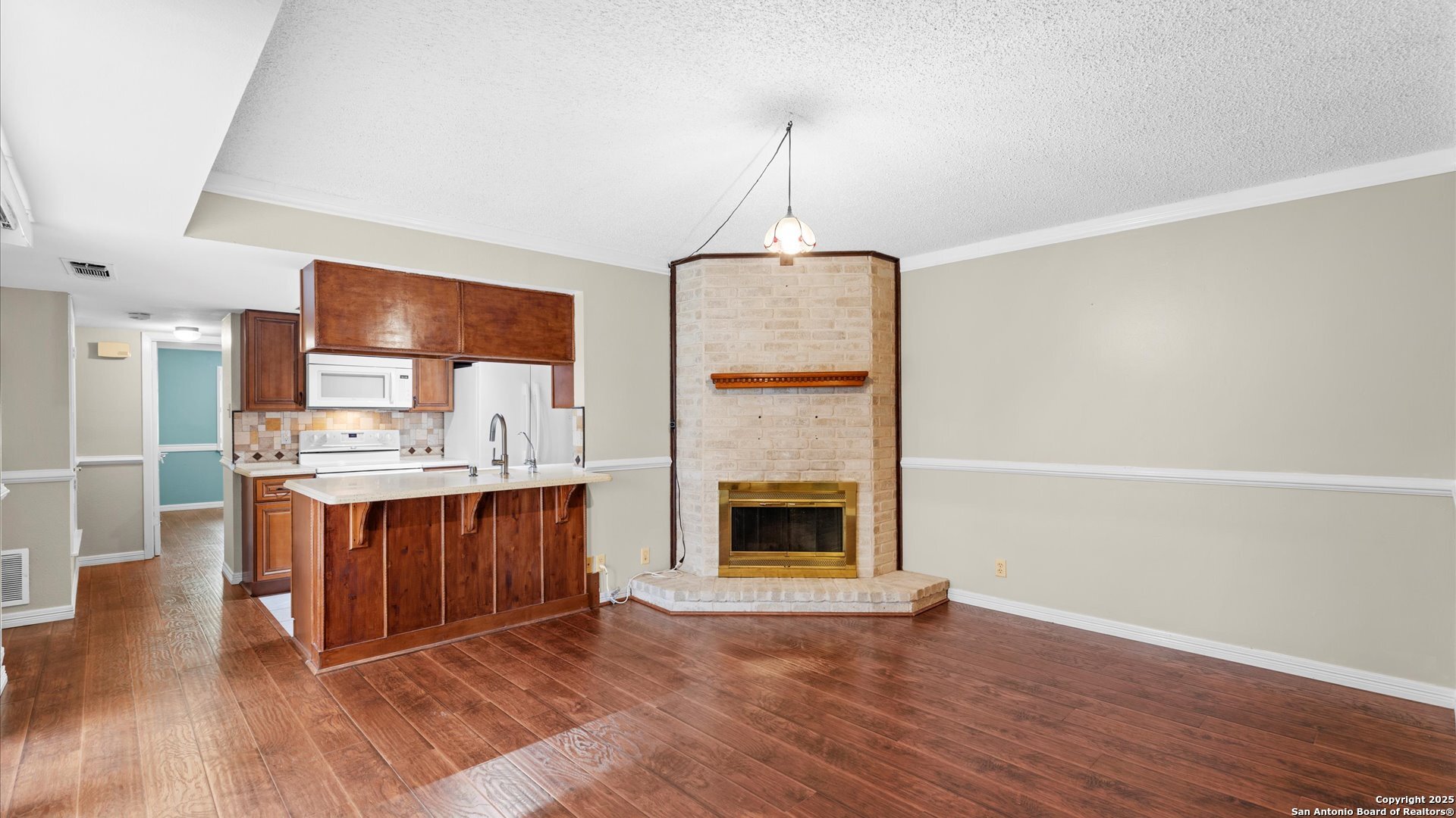 6750 Crown Ridge San Antonio, TX 78239 - Photo 9 of 31 a room with stainless steel appliances granite countertop a sink a stove and a wooden floors