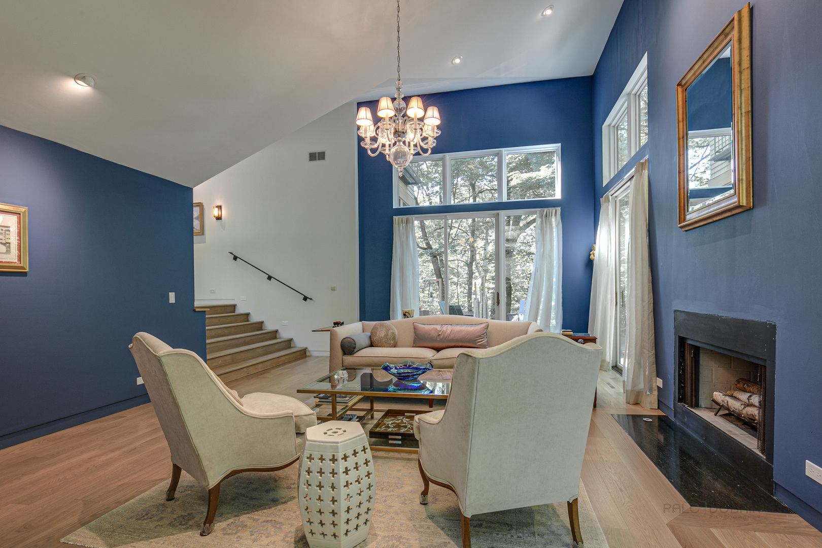 1055 Ringwood Road Lake Forest, IL 60045 - Photo 18 of 59 a living room with furniture chandelier and a fireplace