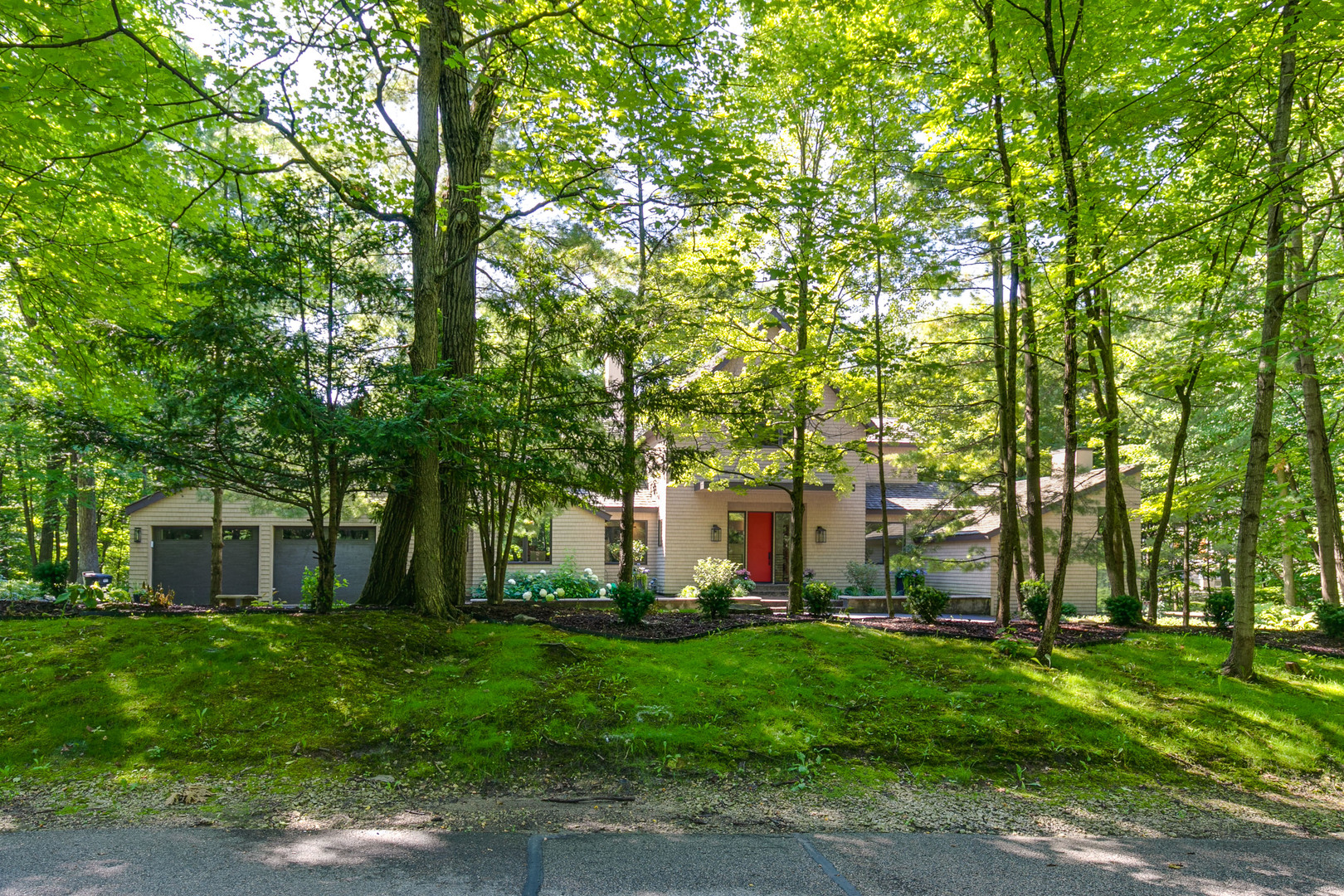 1055 Ringwood Road Lake Forest, IL 60045 - Photo 57 of 59 a view of a white house with a big yard and large trees