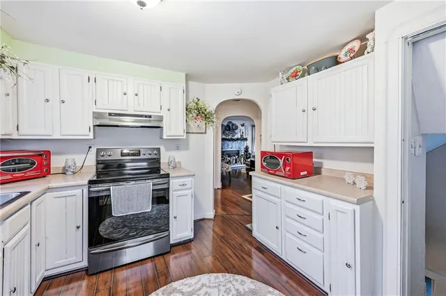 a kitchen with stainless steel appliances granite countertop a refrigerator sink and stove