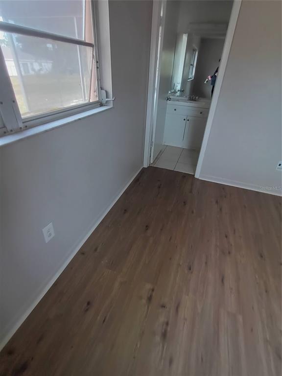 10585 North Spaulding Drive Citrus Springs, FL 34433 - Photo 11 of 18 an empty room with wooden floor and windows