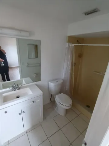 a bathroom with a toilet sink and shower