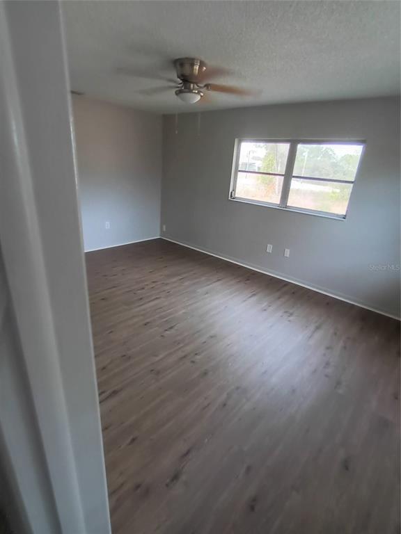 10585 North Spaulding Drive Citrus Springs, FL 34433 - Photo 13 of 18 wooden floor in an empty room with a window