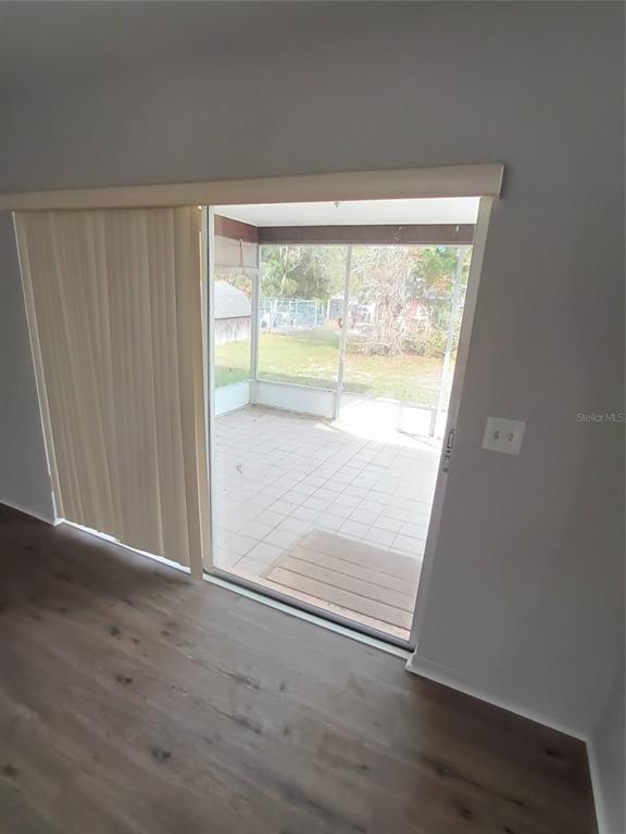 10585 North Spaulding Drive Citrus Springs, FL 34433 - Photo 14 of 18 an empty room with wooden floor and windows