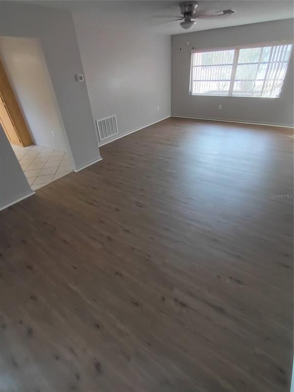 10585 North Spaulding Drive Citrus Springs, FL 34433 - Photo 15 of 18 an empty room with wooden floor and windows