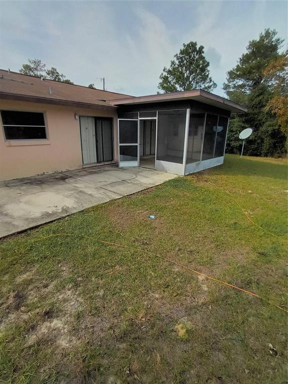 10585 North Spaulding Drive Citrus Springs, FL 34433 - Photo 18 of 18 a front view of a house with a garden
