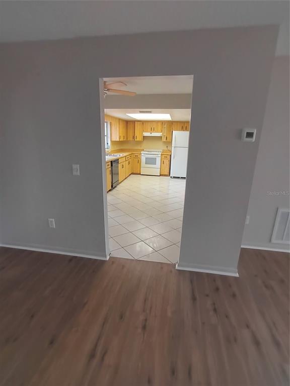 10585 North Spaulding Drive Citrus Springs, FL 34433 - Photo 5 of 18 an empty room with wooden floor and a window