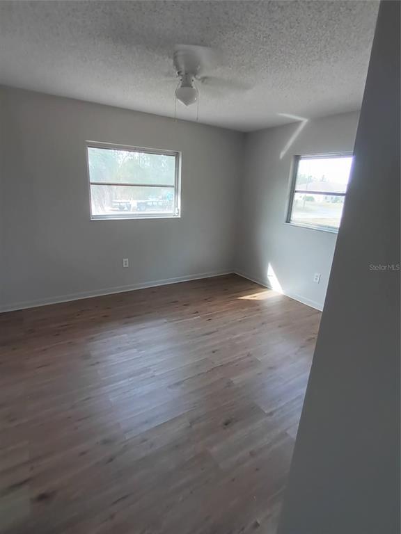 10585 North Spaulding Drive Citrus Springs, FL 34433 - Photo 8 of 18 an empty room with wooden floor windows and closet