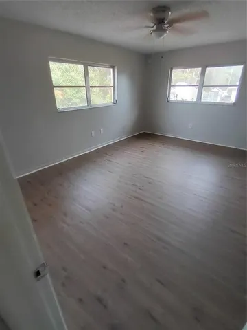an empty room with a empty space and windows