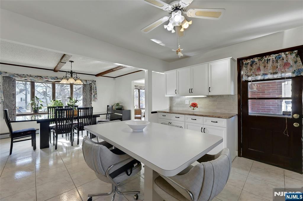 4 Highfield Court Wayne, NJ 07470 - Photo 11 of 49 a kitchen with a dining table chairs and refrigerator