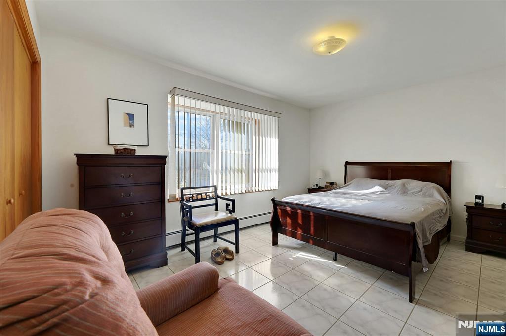 4 Highfield Court Wayne, NJ 07470 - Photo 20 of 49 a bedroom with a bed and chair