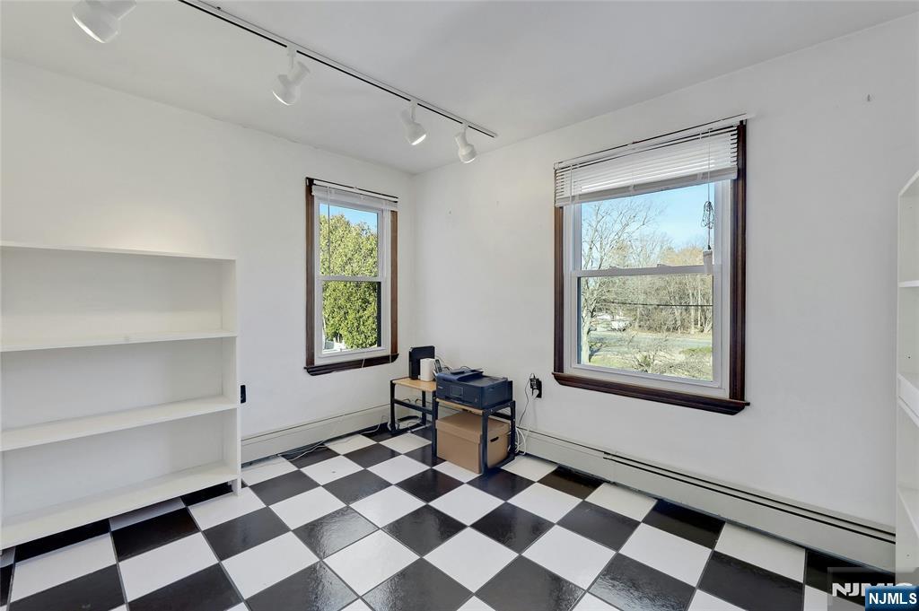 4 Highfield Court Wayne, NJ 07470 - Photo 27 of 49 a room with a black white checkered floor with a gaming machine and table