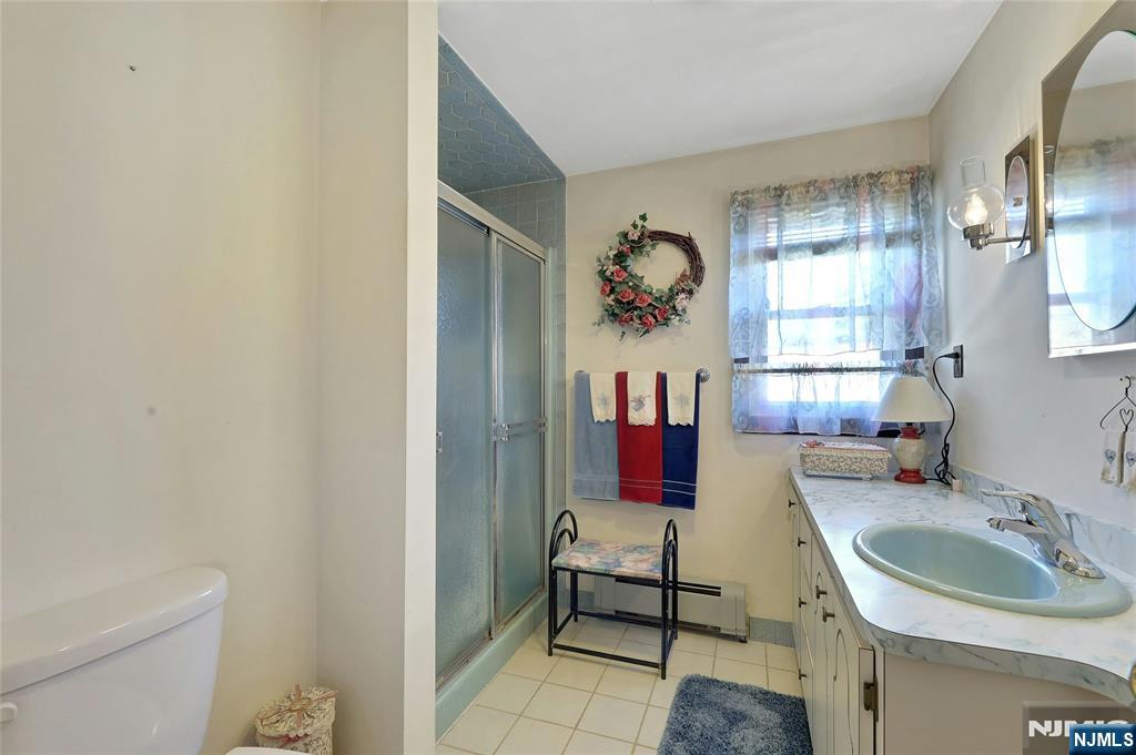 4 Highfield Court Wayne, NJ 07470 - Photo 30 of 49 a bathroom with a sink and a mirror