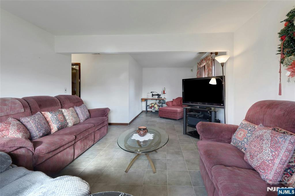 4 Highfield Court Wayne, NJ 07470 - Photo 4 of 49 a living room with furniture and a flat screen tv