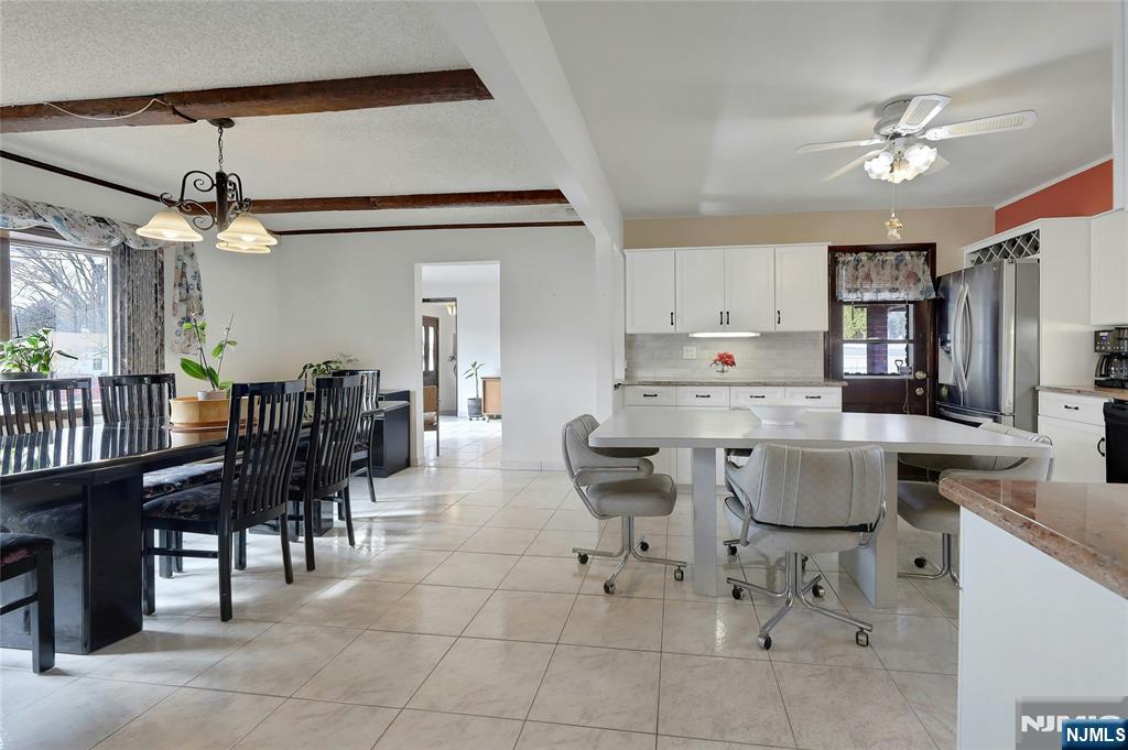 4 Highfield Court Wayne, NJ 07470 - Photo 7 of 49 a kitchen with stainless steel appliances kitchen island granite countertop a table chairs and a refrigerator