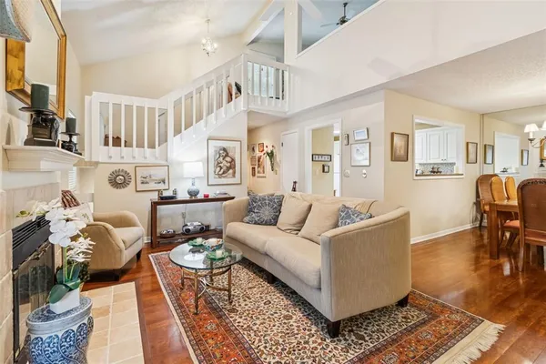 a dining room with furniture a chandelier and wooden floor