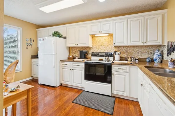 a dining room with furniture and wooden floor