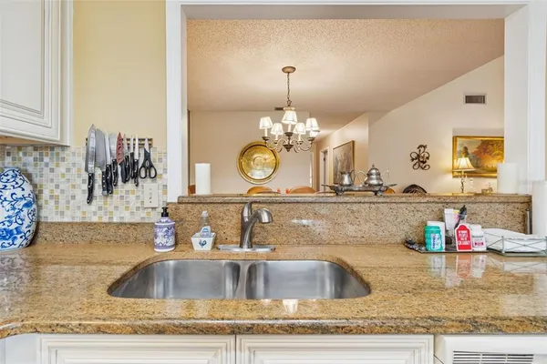 a living room with furniture a rug and a chandelier