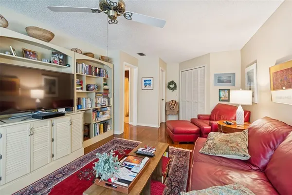 a living room with furniture and a book shelf