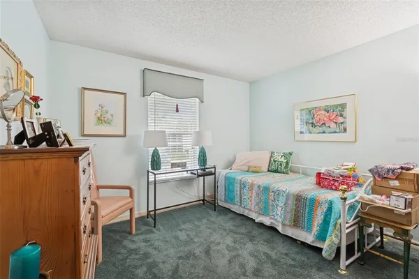 a bedroom with two beds and a window