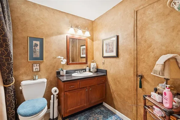 a view of staircase with lots of frames on wall and a window