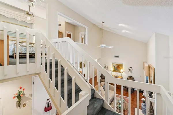 a living room with furniture a flat screen tv and a window