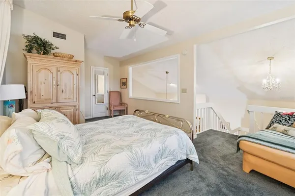 a bathroom with a granite countertop toilet sink and mirror