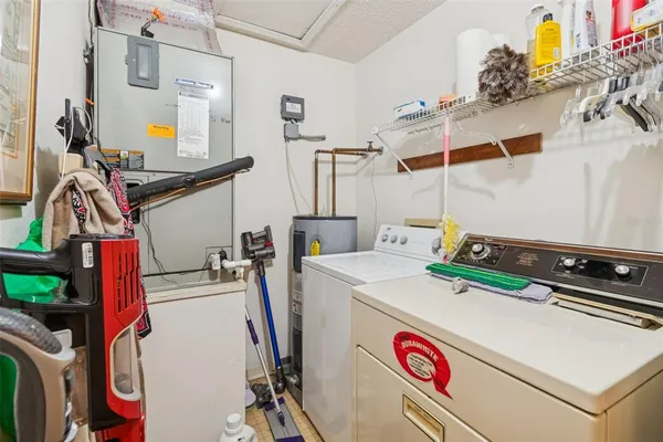a balcony with table and chairs and potted plants
