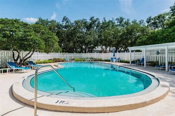 a view of a patio with couches table and chairs potted plants with wooden floor
