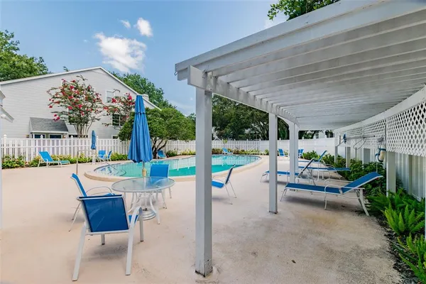 a view of a house with backyard and sitting area