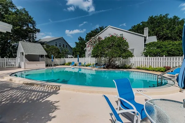 a view of a backyard with swimming pool