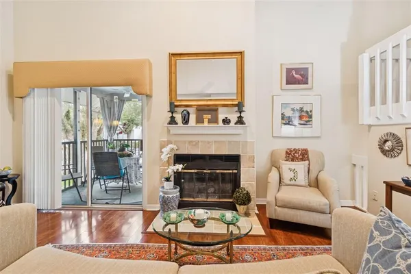a living room with fireplace furniture and a floor to ceiling window