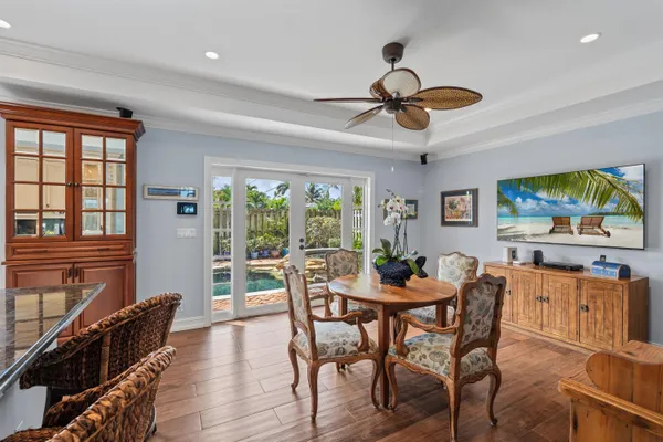 a dining room with furniture a window and wooden floor