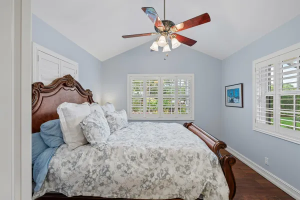 a large bed sitting in a bedroom next to a window