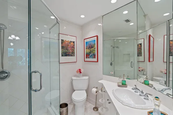 a bathroom with a sink toilet and shower
