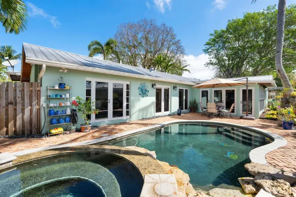 a swimming pool with outdoor seating and yard