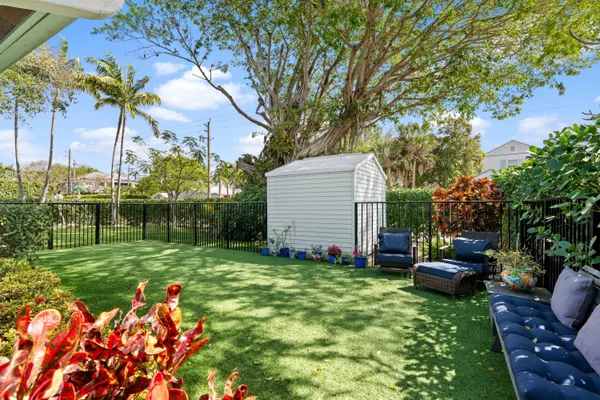 a backyard of a house with lots of green space and fountain