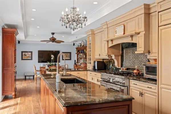 a kitchen with stainless steel appliances granite countertop a stove and cabinets