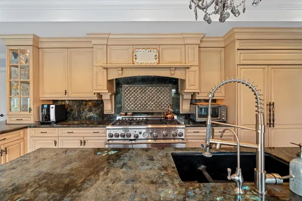 a kitchen with a stove a sink and a microwave