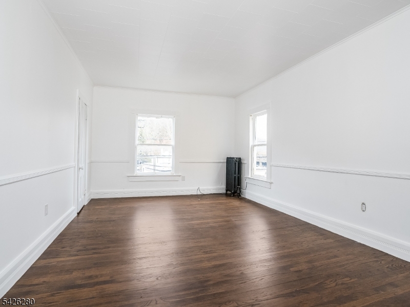 68 High Street Newton, NJ 07860 - Photo 12 of 31 a view of an empty room with wooden floor and a window