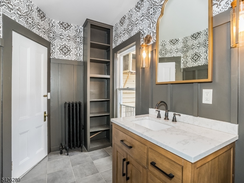 68 High Street Newton, NJ 07860 - Photo 18 of 31 a bathroom with a sink vanity and a mirror
