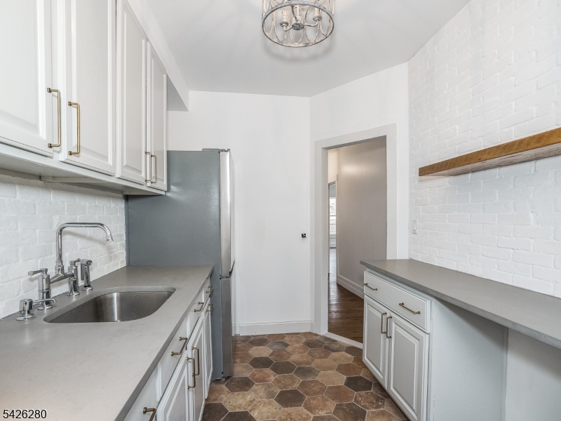 68 High Street Newton, NJ 07860 - Photo 19 of 31 a kitchen with stainless steel appliances granite countertop a sink and a refrigerator