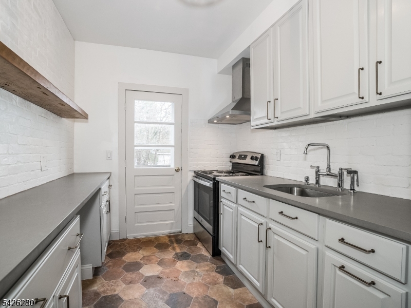 68 High Street Newton, NJ 07860 - Photo 21 of 31 a kitchen with granite countertop white cabinets and white appliances