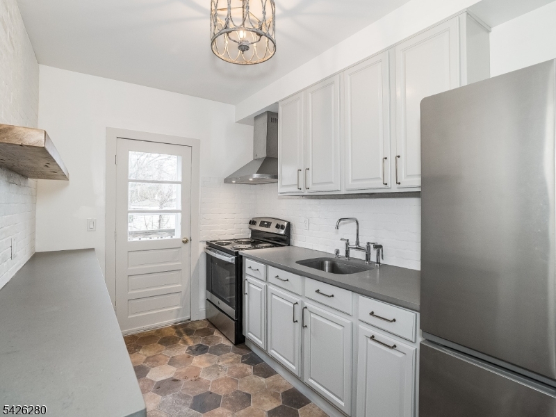 68 High Street Newton, NJ 07860 - Photo 22 of 31 a kitchen with stainless steel appliances granite countertop a sink a stove a refrigerator and cabinets