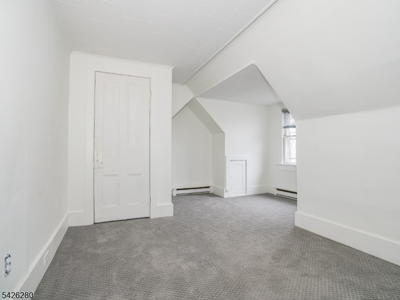 68 High Street Newton, NJ 07860 - Photo 25 of 31 an empty room with windows and natural light
