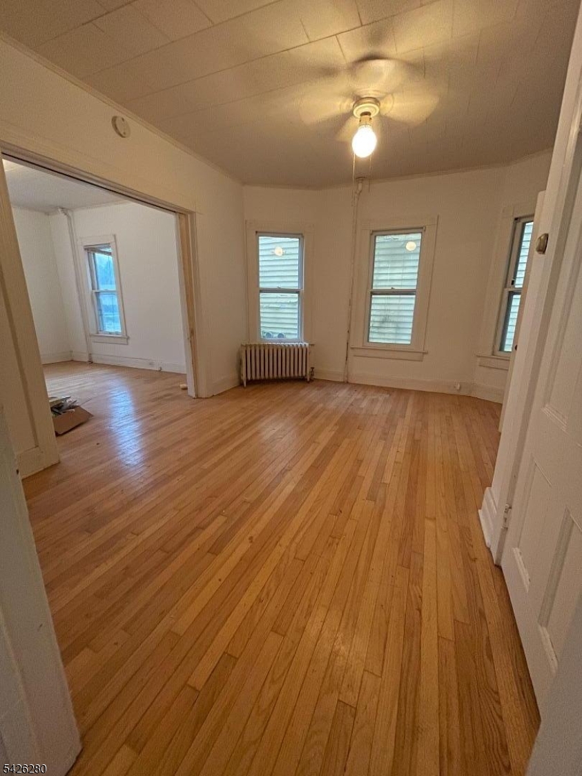 68 High Street Newton, NJ 07860 - Photo 30 of 31 wooden floor in an empty room with a window