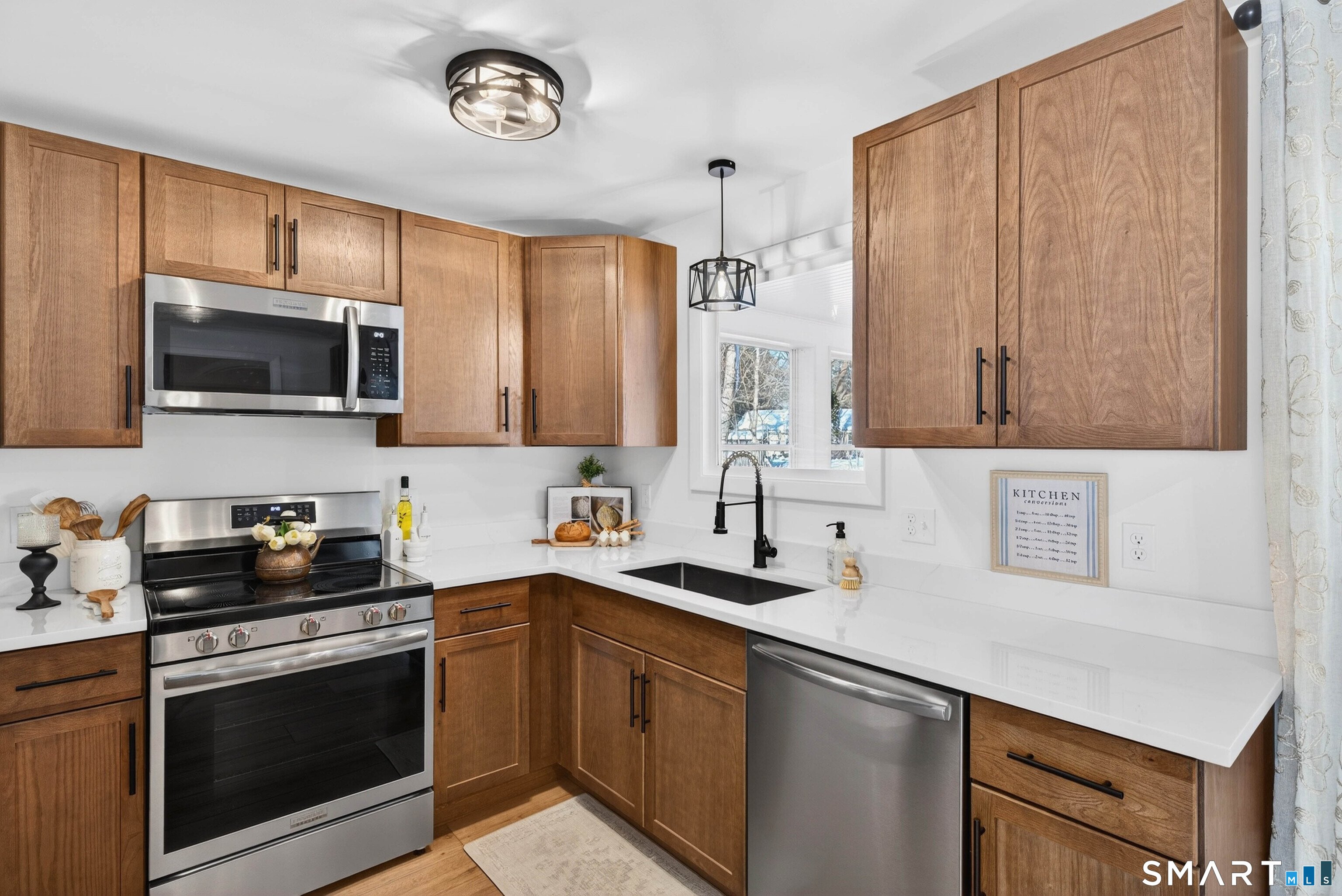 168 Park Avenue Colchester, CT 06415 - Photo 12 of 40 a kitchen with stainless steel appliances a sink a stove a microwave and cabinets